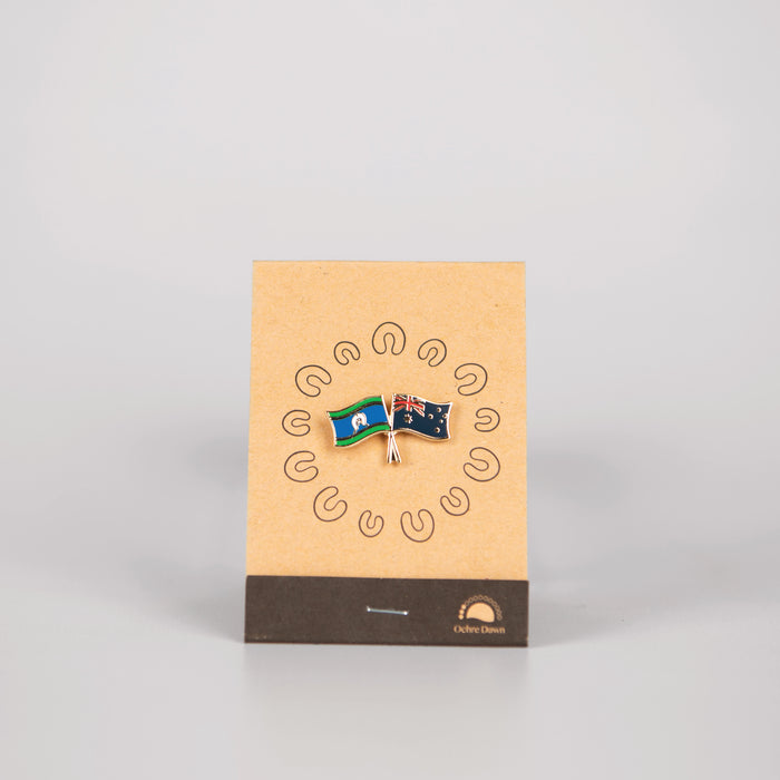 lapel pin of australia and torres strait islander on brown backing card