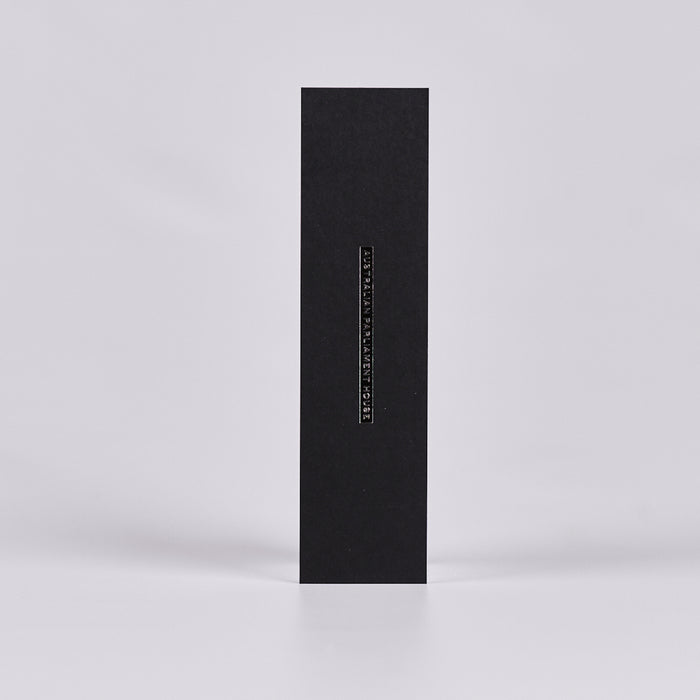 Back of a black bookmark with text reading 'Australian Parliament House'.