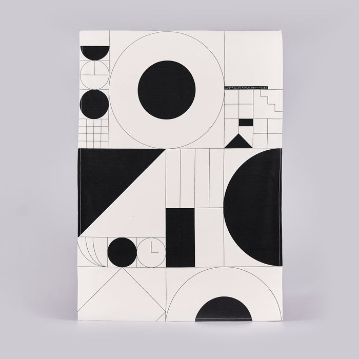 Tea towel with a black and white geometric design.