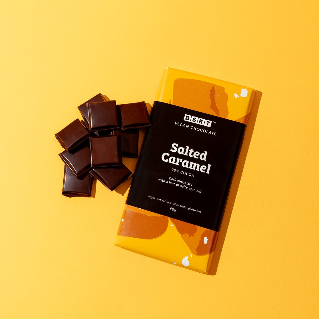 Yellow chocolate block with the words 'Salted Caramel' on the front with loose chocolate blocks on the side.