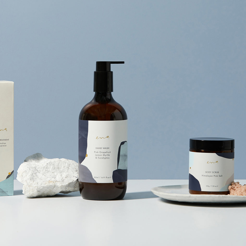 Ena foot treatment, hand wash and body scrub products in their packaging with a light blue background