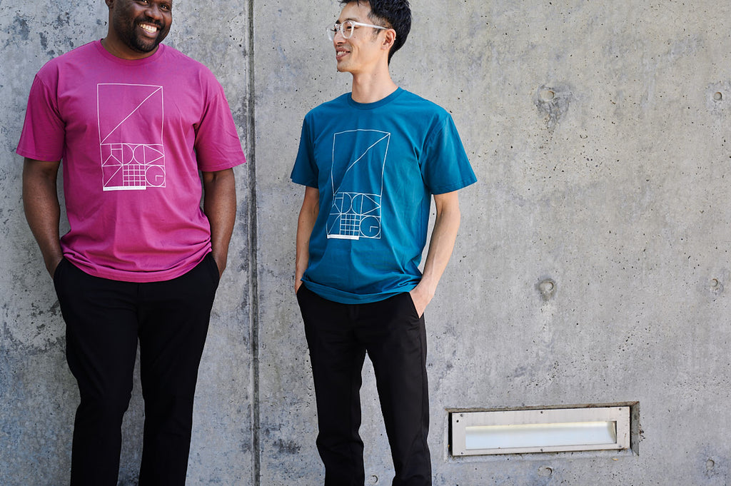 Two men wearing Parliament Shop t-shirt in berry and atlantic colours.