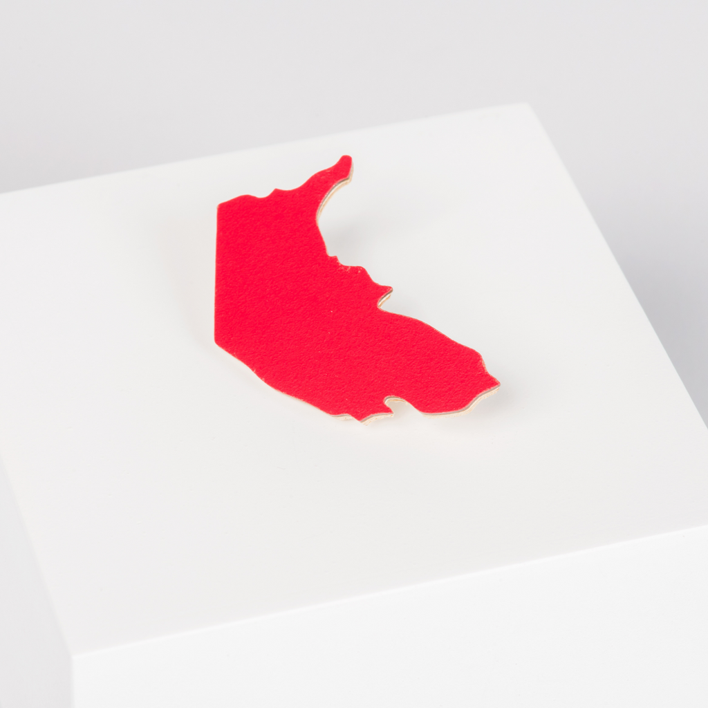 Wooden red brooch in the shape of the Australian Capital Territory 