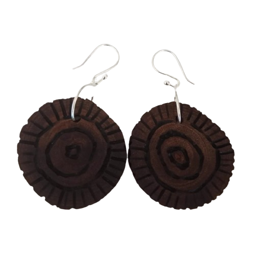 pair of wooden earrings featuring circular carvings