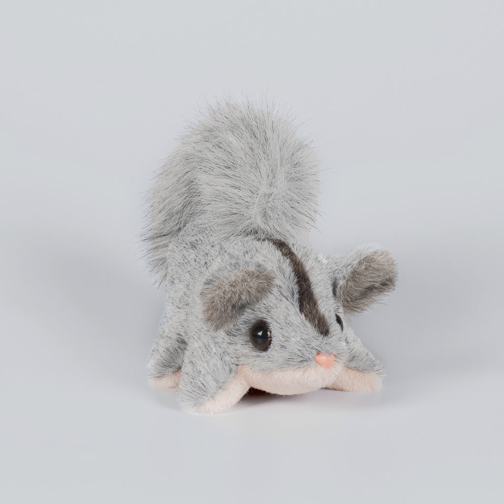Grey and pink possum plush toy.