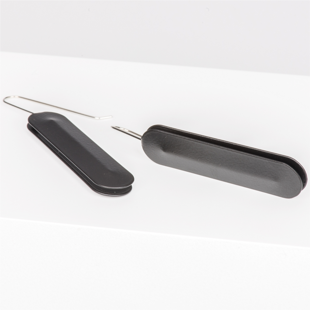 Dangle earrings featuring long black oval pendants