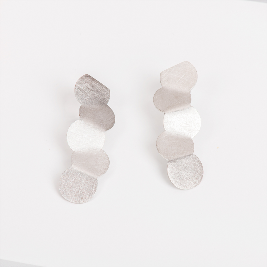 Minimalist stainless steel earrings featuring a line of circles