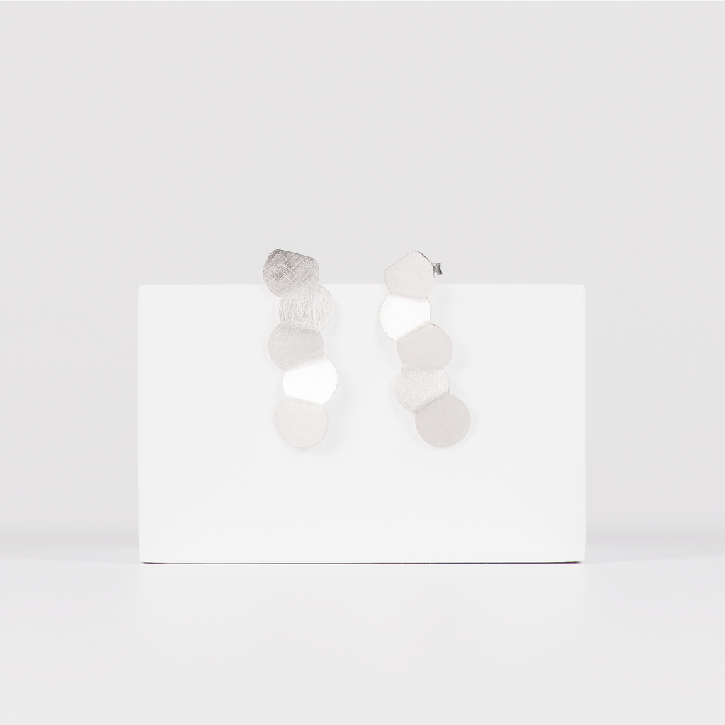 Minimalist stainless steel earrings featuring a line of circles