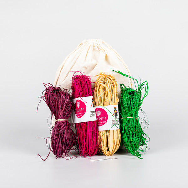 four colourful raffia bundles and a sail makers needle presented with drawstring bag