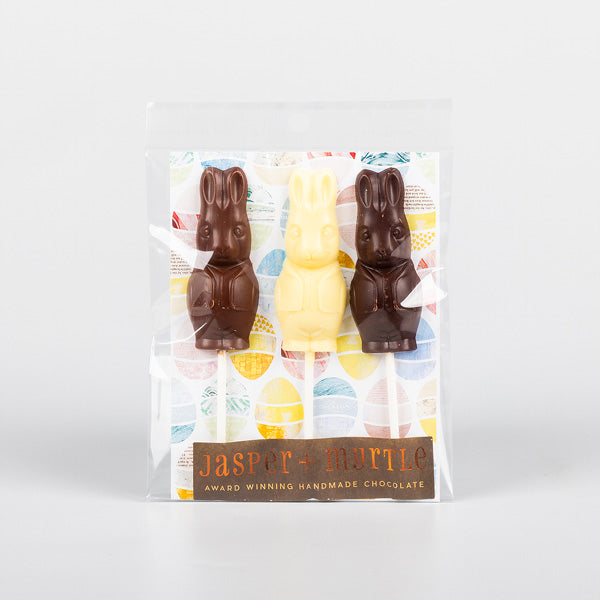 three chocolate bunny lollipops in its plastic packaging