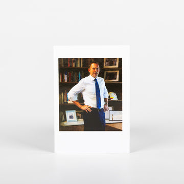 postcard of portrait of prime minister Tony Abott standing staring at us