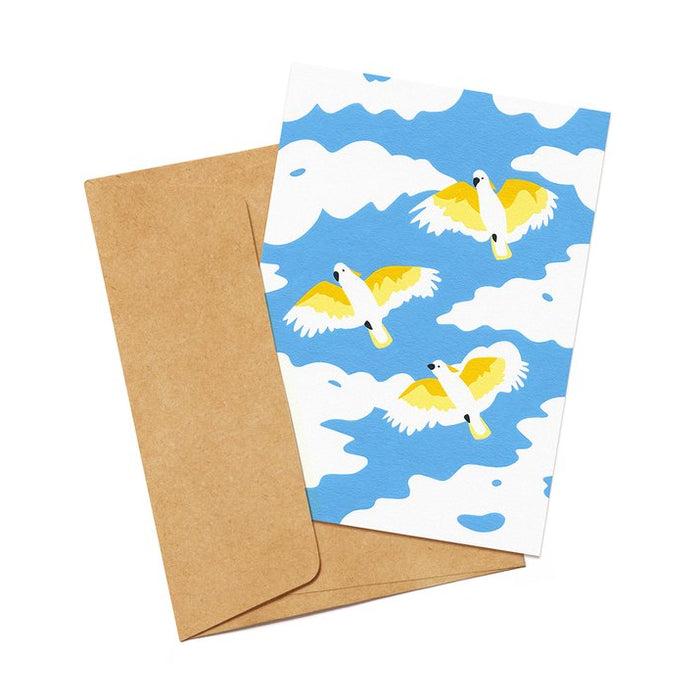 Gift card featuring an illustration of flying Cockatoos and a brown envelope