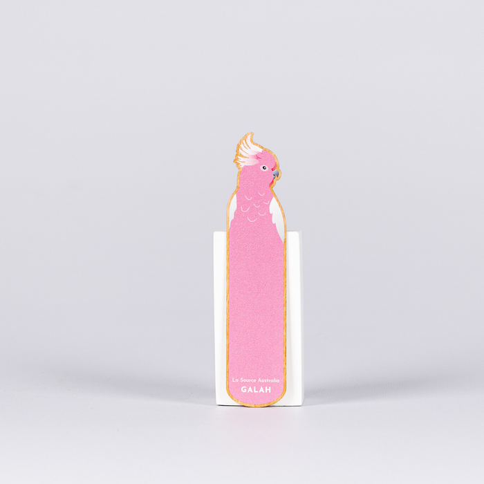 Pink bird-shaped notepad with a white background