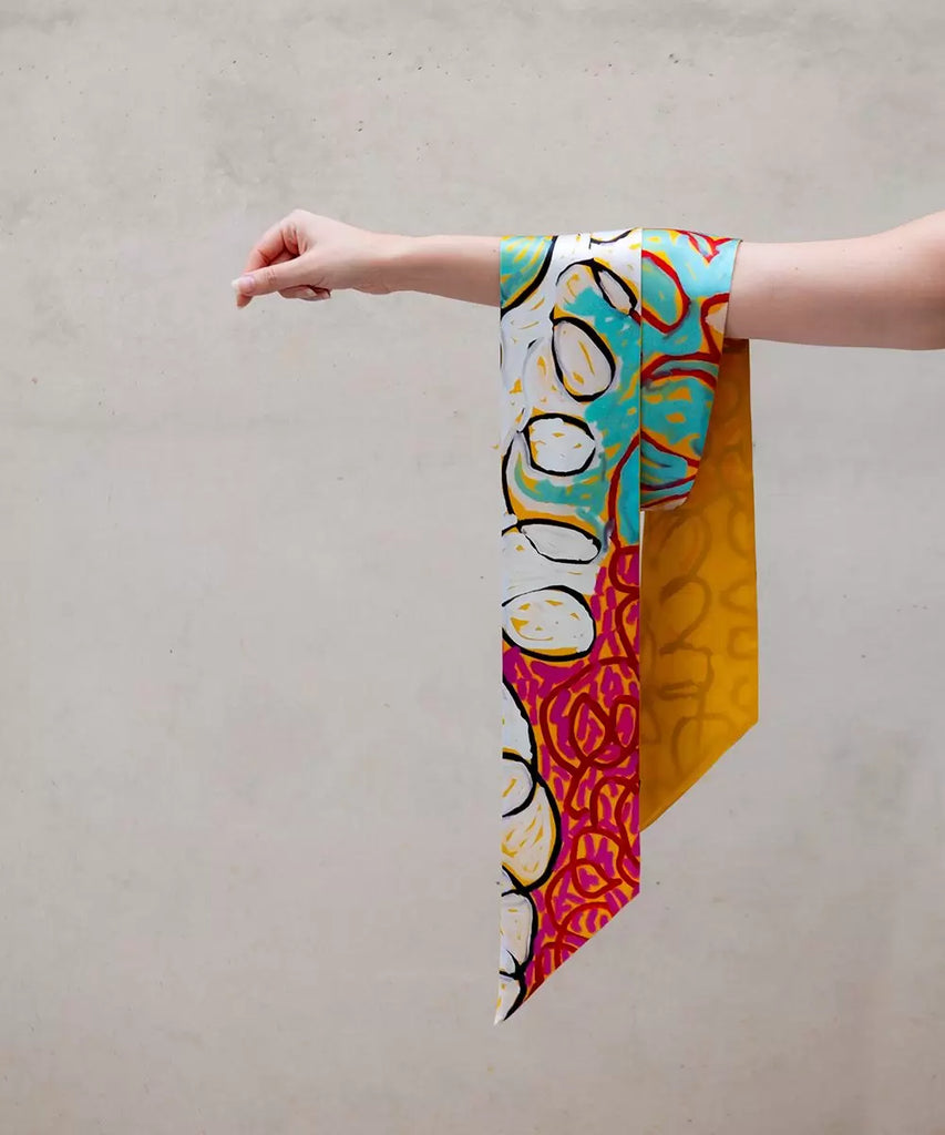 vibrant silk scarf hanging from an arm