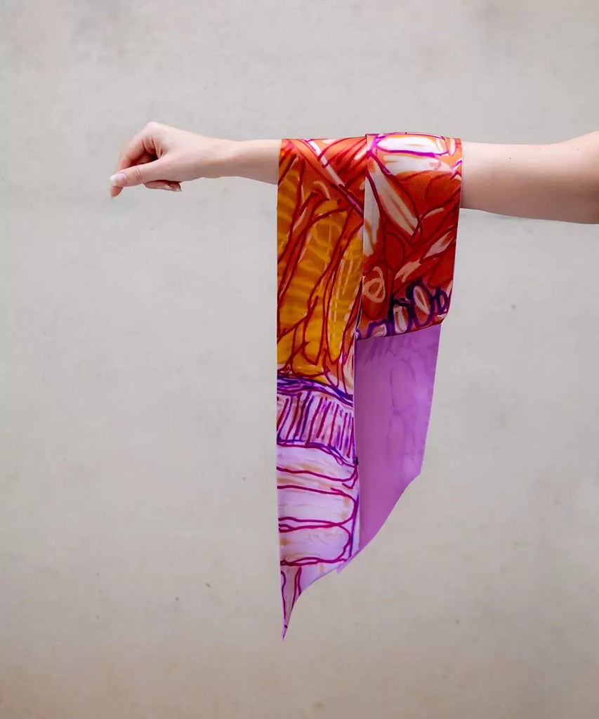 vibrant silk scarf hanging from an arm