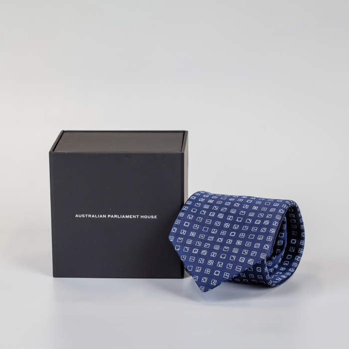 rolled navy blue tie with small square pattern and black display box