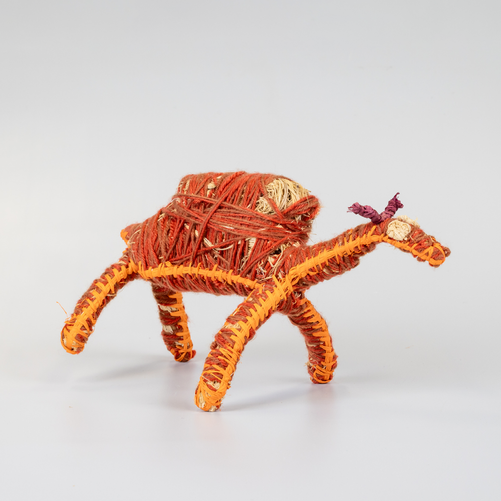 Grass woven camel sculpture in red and orange