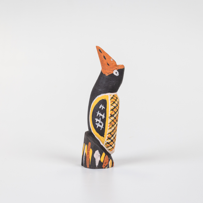 small black and yellow wooden bird sculpture