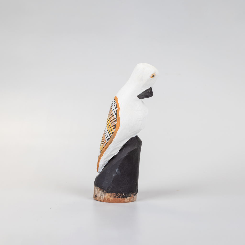 small black and white wooden bird sculpture