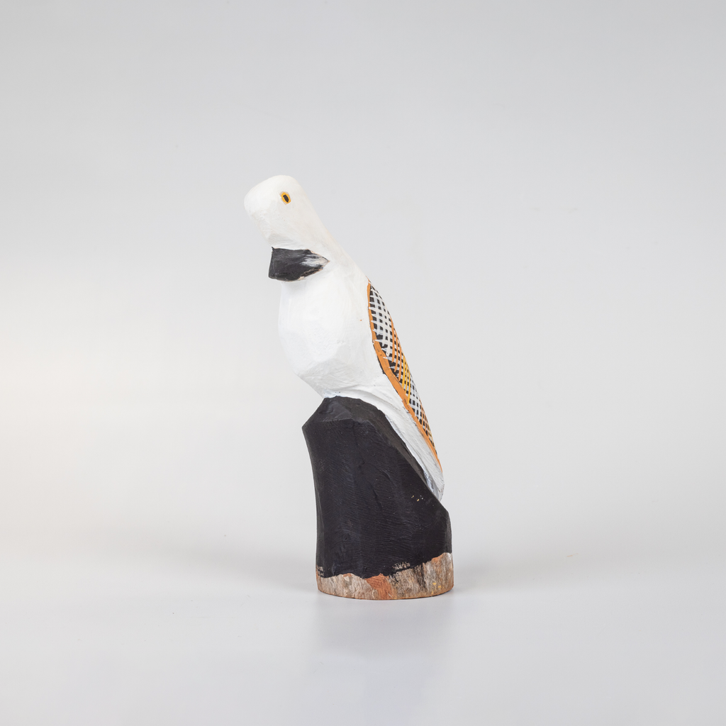small black and white wooden bird sculpture