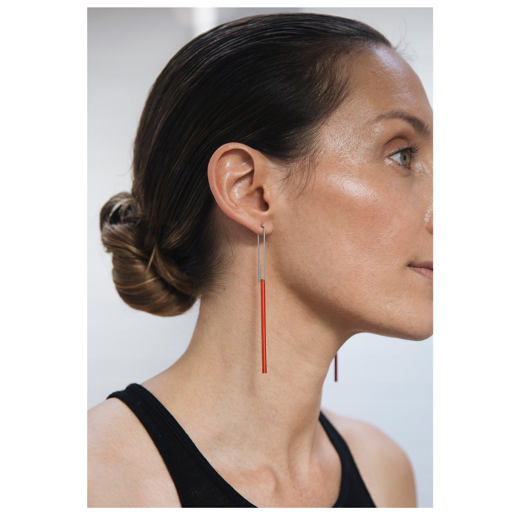 woman wearing Minimalist stainless steel drop earrings featuring red long bar