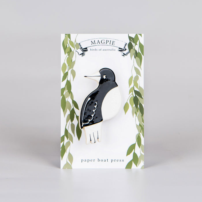 ceramic magpie brooch on backing card