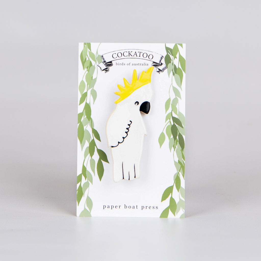 ceramic cockatoo brooch on backing card