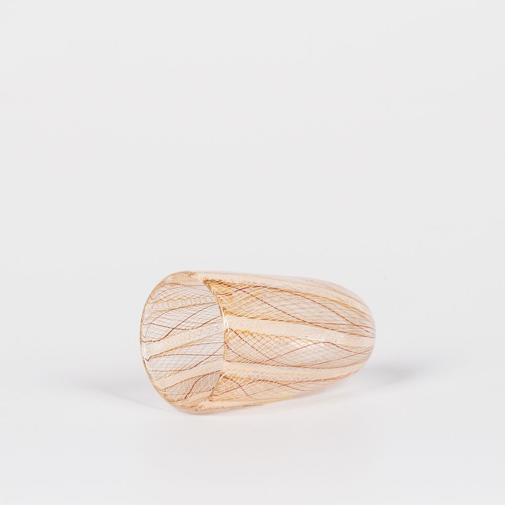 Miniature rounded glass vessel with intricate yellow and brown swirl design