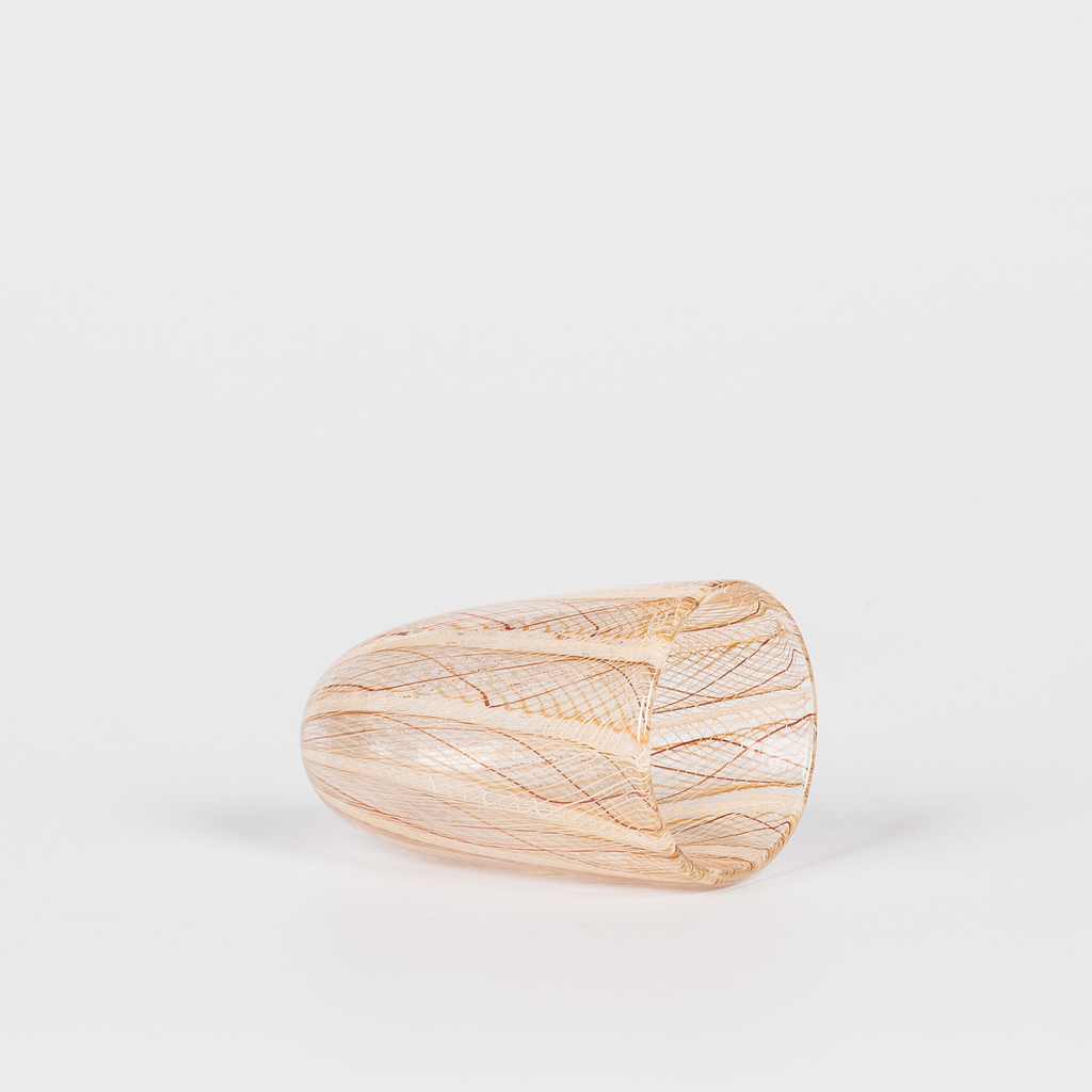 Miniature rounded glass vessel with intricate yellow and brown swirl design