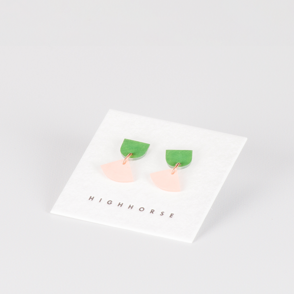 colourful stud earrings featuring small triangle charm  on backing card