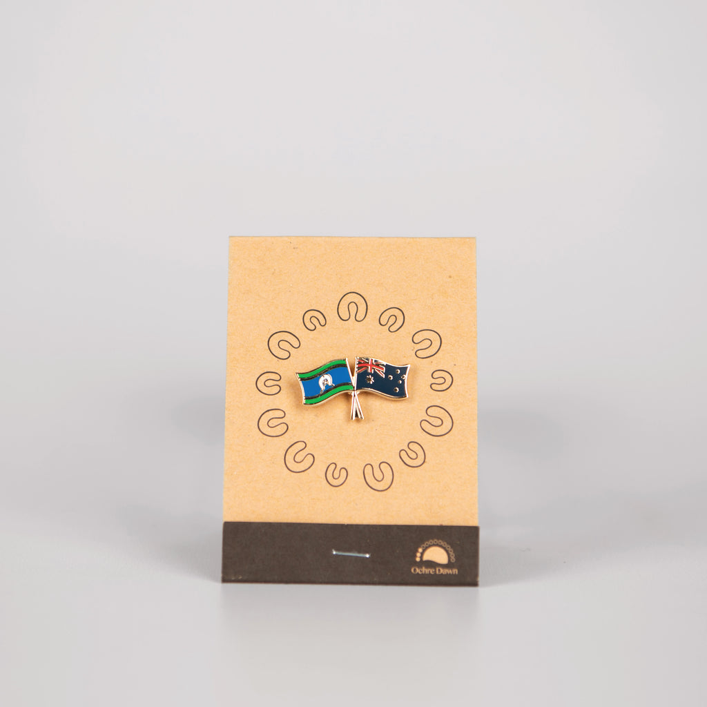 lapel pin of australia and torres strait islander on brown backing card