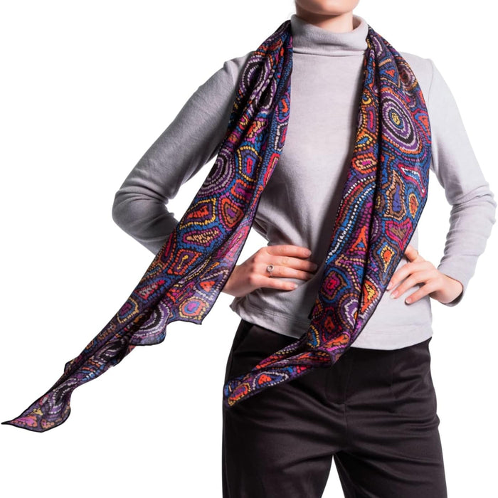 woman wearing purple wool scarf with traditional patterns 