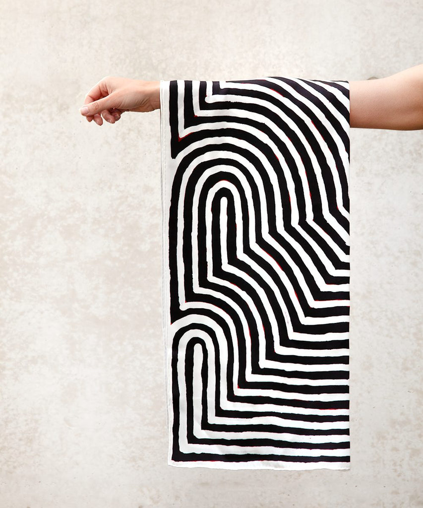 large black and white silk scarf hanging off arm