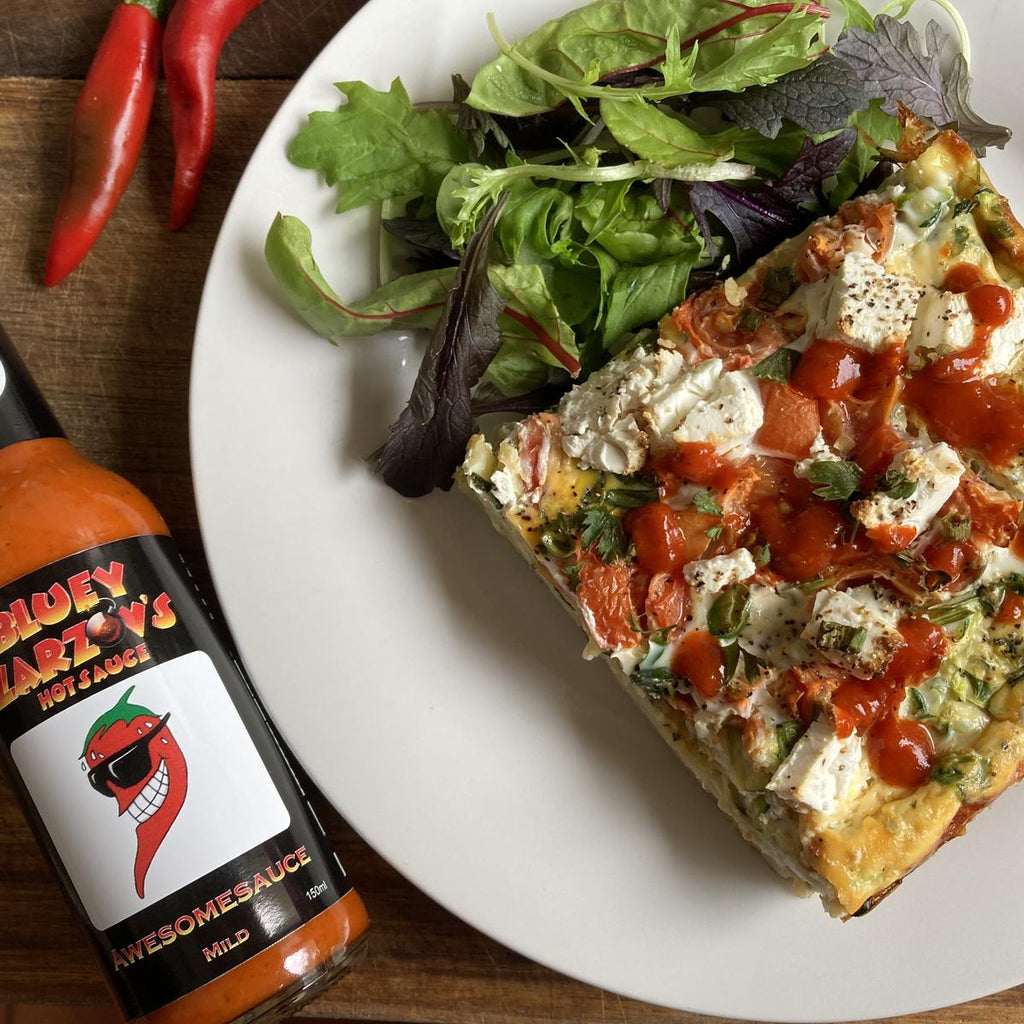 flatlay of Bluey Zarzov's hotsauce (150ml) with a plate of Frittata and salad