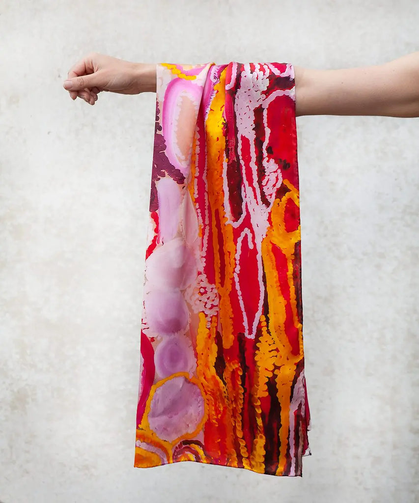 colourful silk scarf with traditional patterns hanging on arm