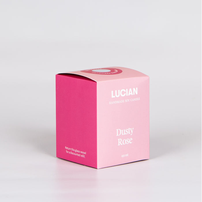 Pink candle box with the words 'Lucian handmade soy candle Dusty Rose' on the front.