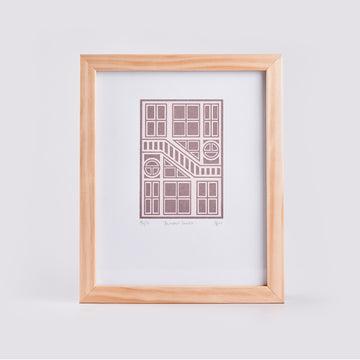 artwork with pink geometric design and a white background in a timber frame