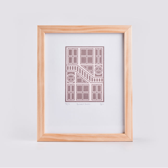 artwork with pink geometric design and a white background in a timber frame