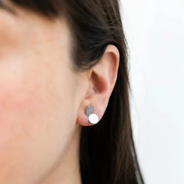 woman wearing double dot shaped stud earrings 