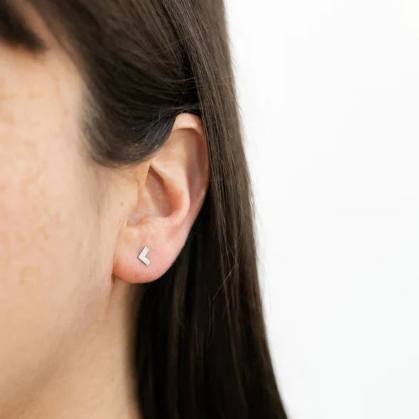 woman wearing stainless steel arrow shaped stud earrings