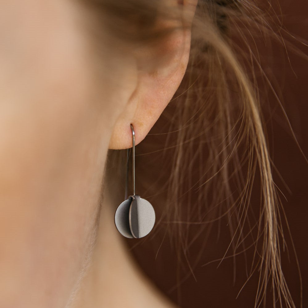 woman wearing Dangle earrings featuring folded dot pendants