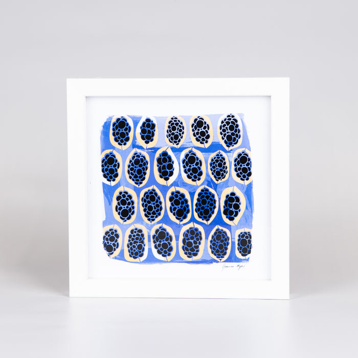 Artwork with blue and black oval shapes and a blue background in a white timber frame.