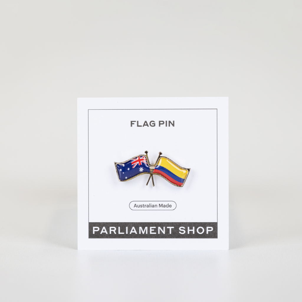 Lapel pin of Australia and Colombia flags on white backing card