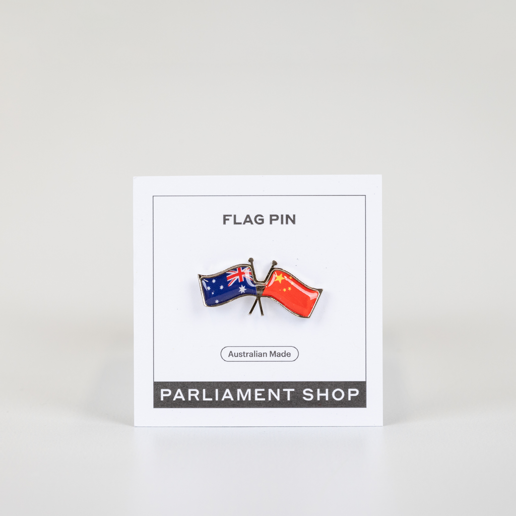 Lapel pin of Australia and China flags on white backing card