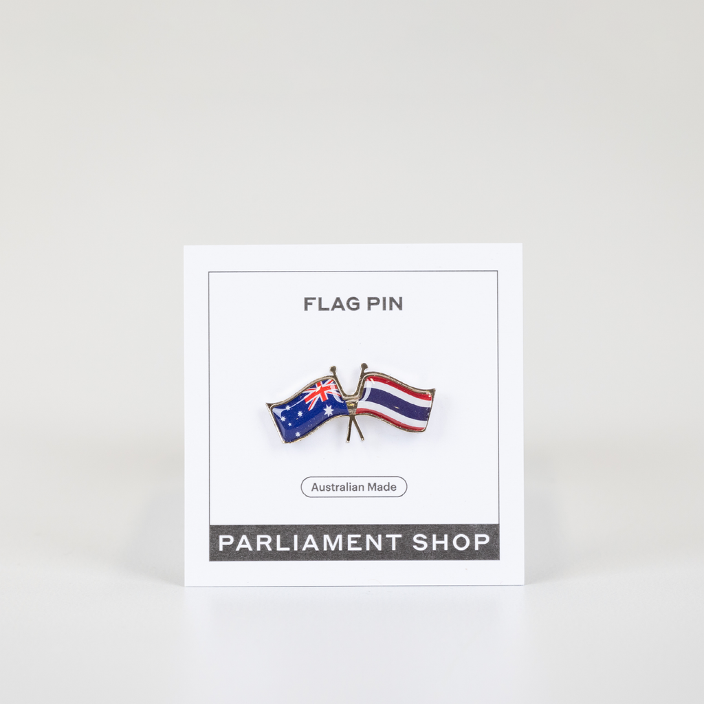 Lapel pin of Australia and Thailand flags on white backing card