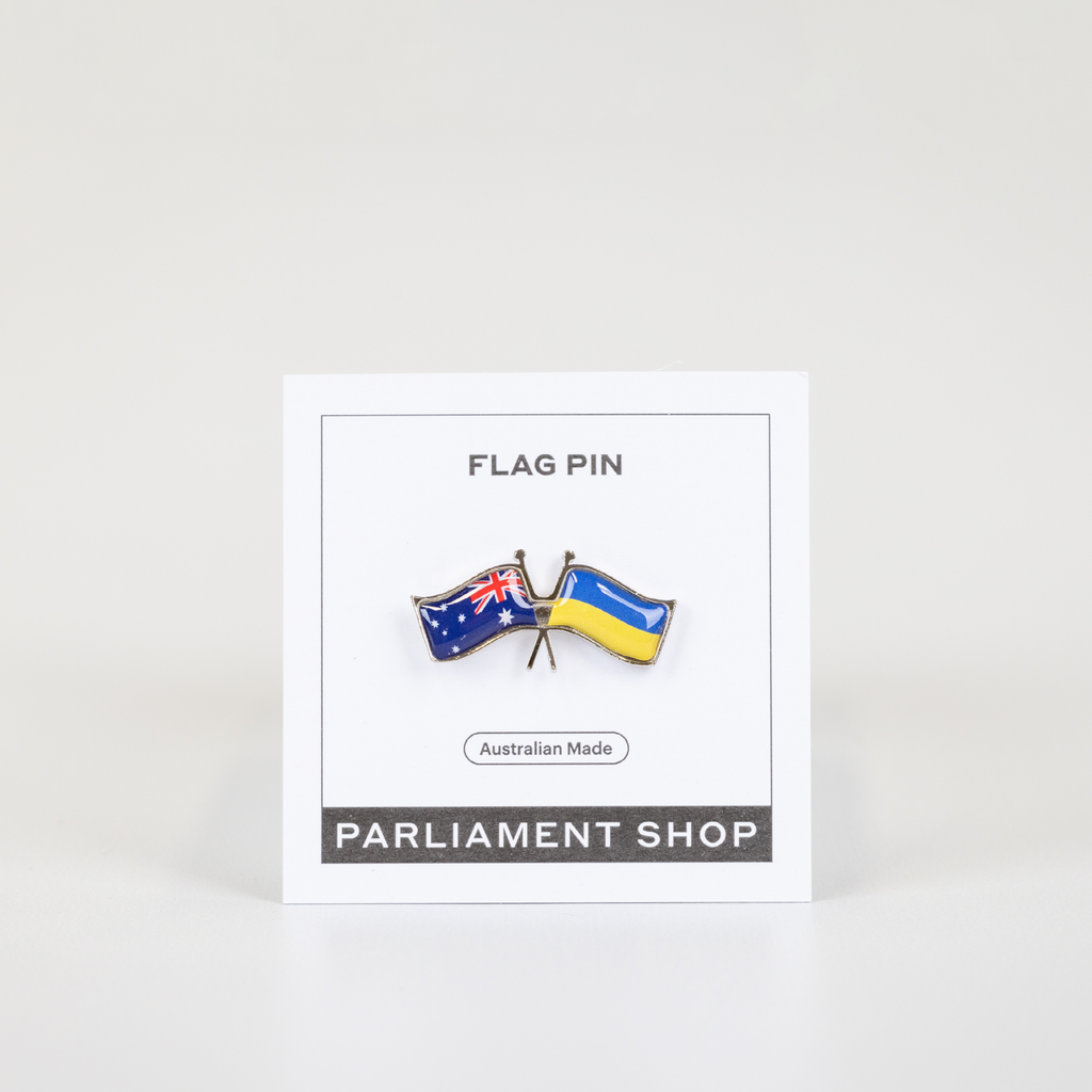 Lapel pin of Australia and Ukraine flags on white backing card