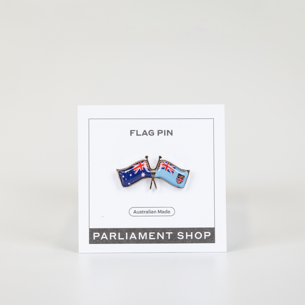 Lapel pin of Australia and Fiji flags on white backing card