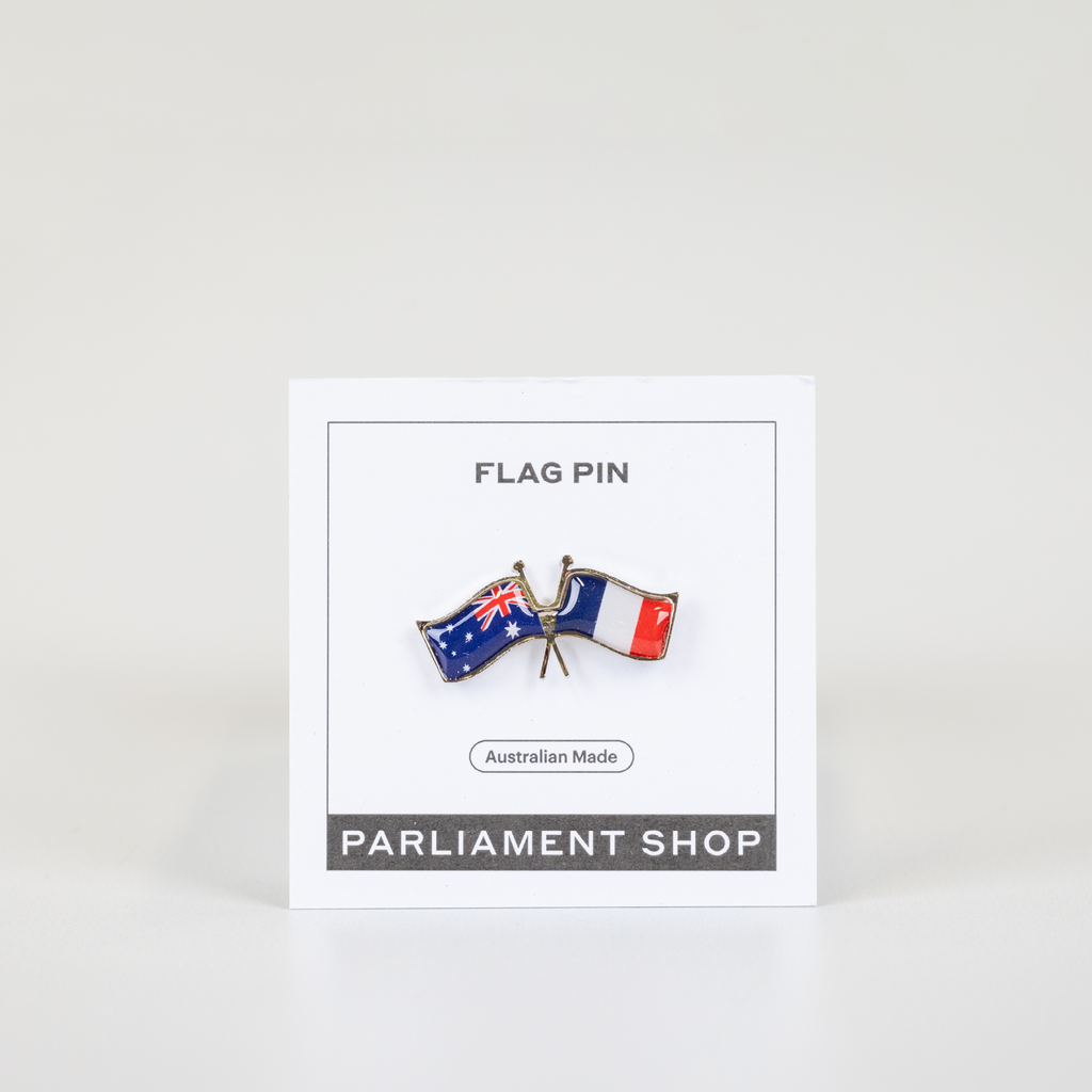 Lapel pin of Australia and France flags on white backing card