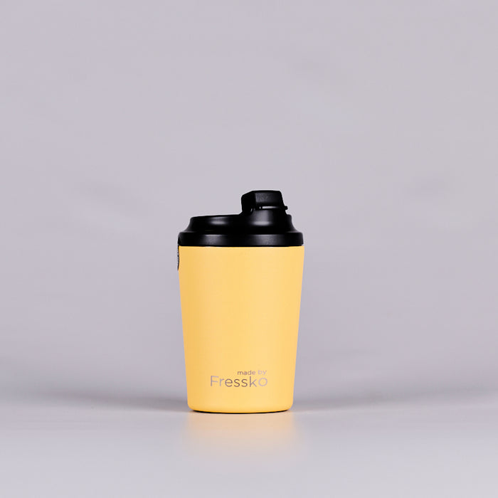 Yellow reusable coffee cup text reading 'made by Fressko'.