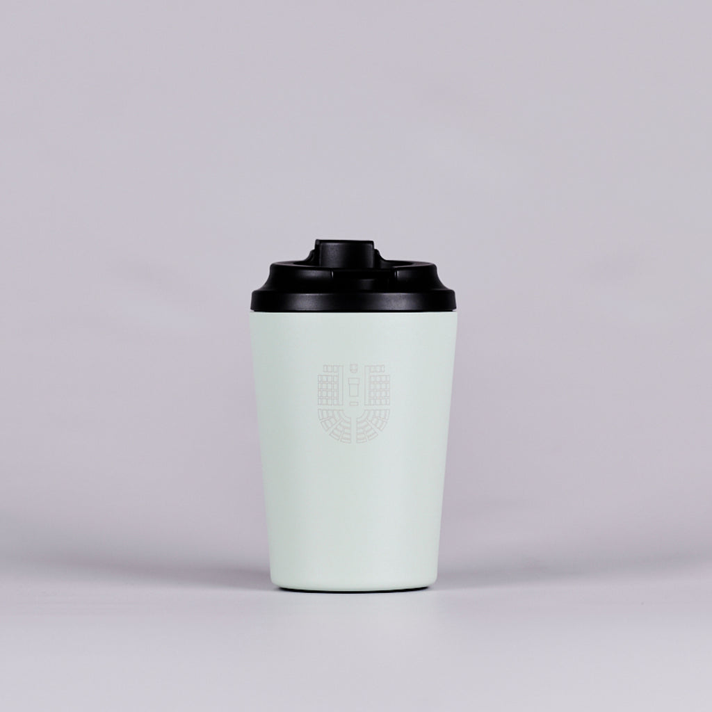 Green reusable coffee cup with black House of Representatives Chamber seating plan.